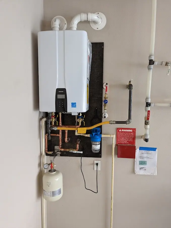 Professional plumber installing copper piping in a Mount Lebanon home